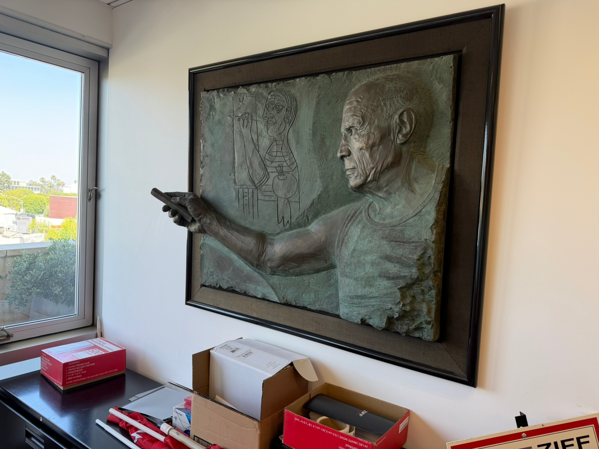 Picasso bronze relief artwork displayed inside the California Luxury Investments office.