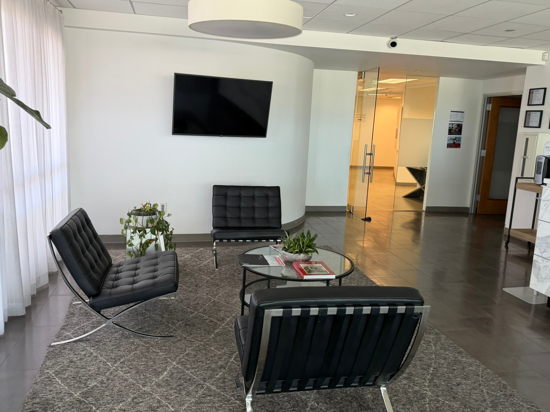 Client lounge with Barcelona chairs at California Luxury Investments, Beverly Hills.