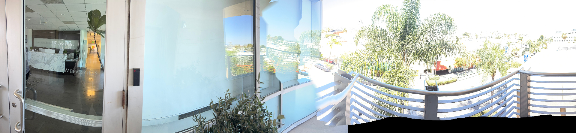 California Luxury Investments office entry and balcony view over Beverly Hills.