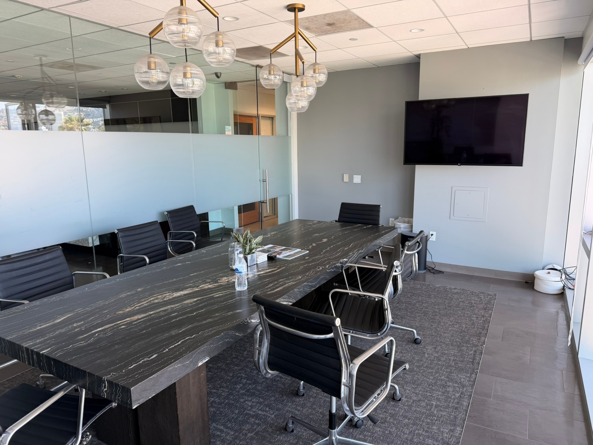 Executive boardroom with marble table at California Luxury Investments, Beverly Hills.